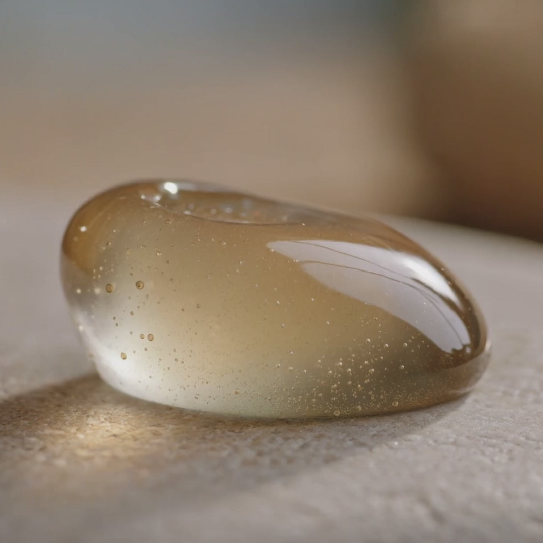 Texture du Gel Booster Caféine Glimoir femme, gel translucide doré qui rebondit sous la pression du doigt